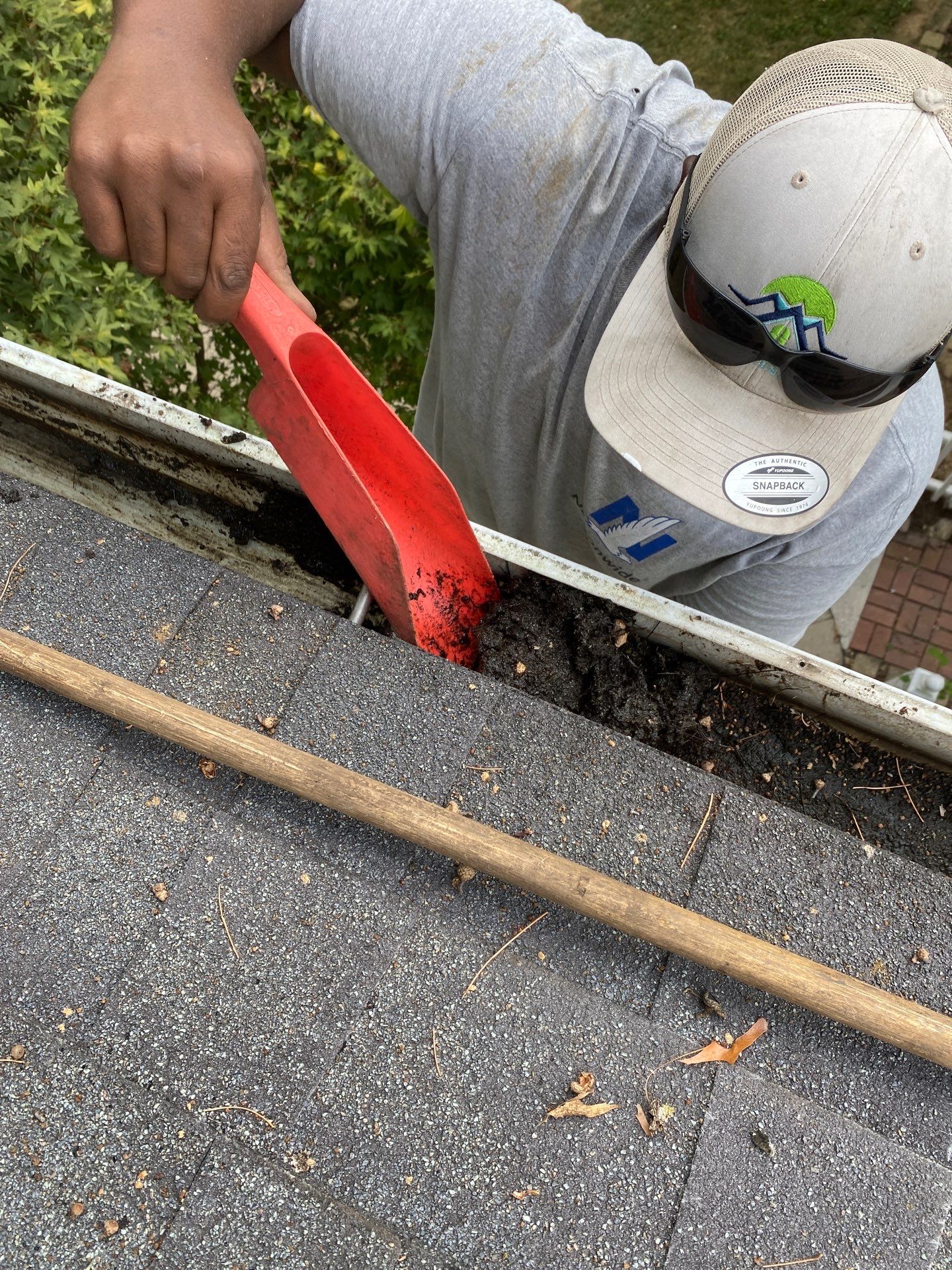 Technician cleaning residential gutters in Sadieville, Kentucky