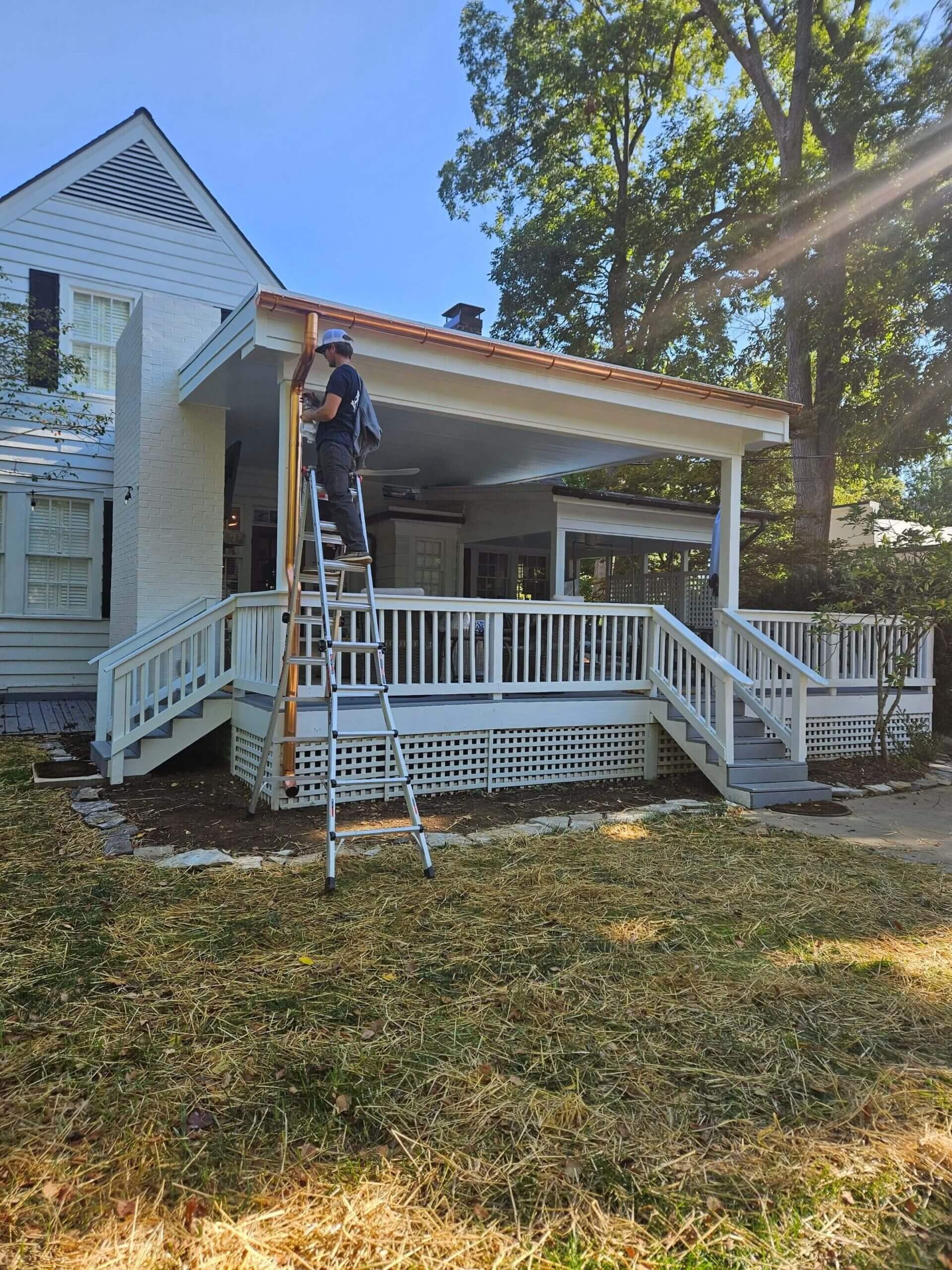 M&M Gutter technician maintaining a residential gutter system in Kentucky